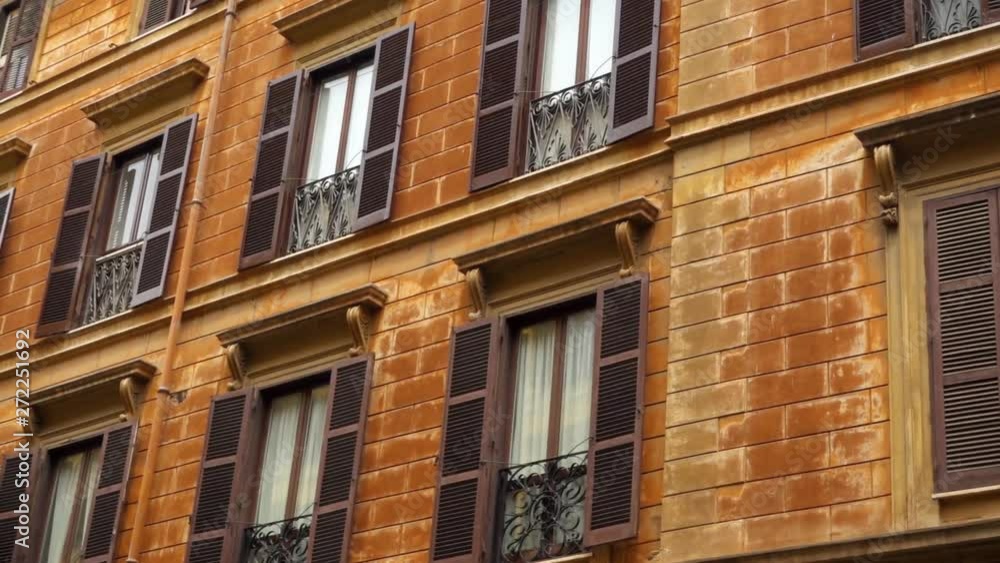 Beautiful european urban architecture. Exterior of old residential building in center of Rome, Italy. Colorful facade of roman house. Camera moving sideways, dolly shot Beautiful european urban architecture. Exterior of old residential building in center of Rome, Italy. Colorful facade of roman house. Camera moving sideways, dolly shot