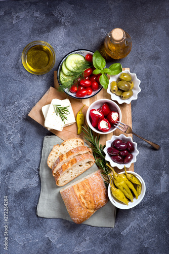 Mediterranean traditional snack with olives, pepperoni, ciabatta, olive oil, italian or greek food concept