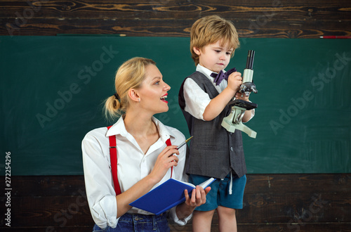 Education university and school system in The United States of America. Tutor teacher giving private lessons to preschool boy. Teacher talking at lesson. Back to school.