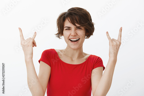 So cool hard rock-n-roll. Cheerful sassy playful attractive woman having fun dancing enjoy awesome music festival great party show heavy metal gesture smiling delighted squinting pleased photo