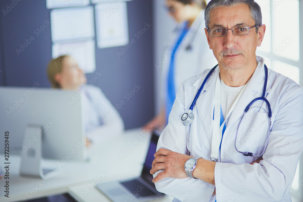 Portrait of a smiling doctor in his bright office Portrait of a smiling doctor in his bright office