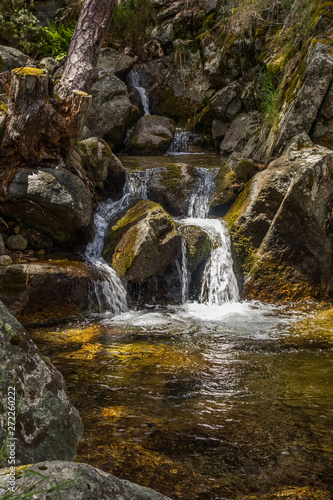 Waterfall in the forest. Lozoya river. Hiker route in the "Sierra de Guadarrama" National Park, Madrid, Spain.