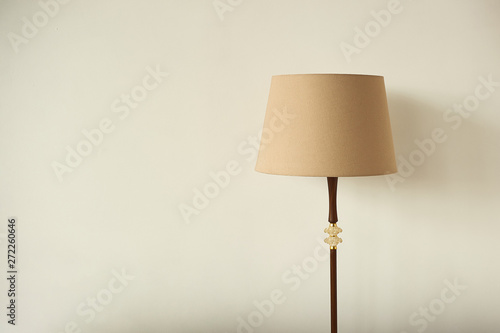 Lampshade on the background of an empty wall. Horizontal photo with place for writing.