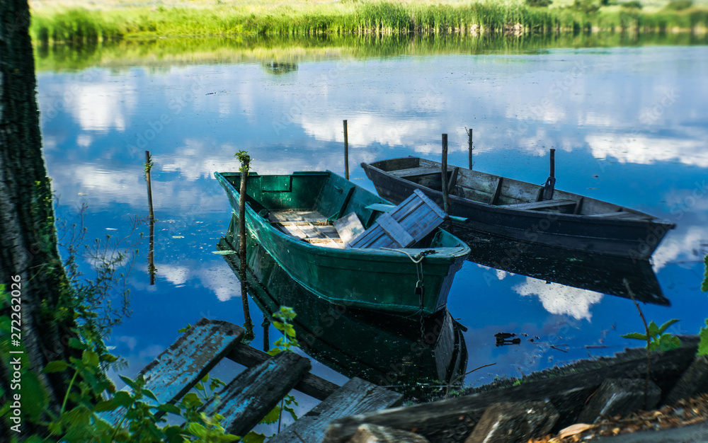 Old wooden boats on the shore of a marshy river. Rustic landscape of Louisiana, USA Old wooden boats on the shore of a marshy river. Rustic landscape of Louisiana, USA