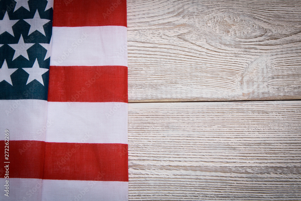 American flag on a wooden background. The concept of freedom and patriotism. American flag on a wooden background. The concept of freedom and patriotism.