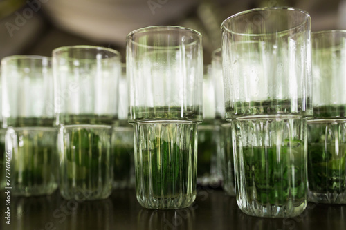A lot of cocktails at the bar at the wedding party. Glasses with mojito with a slice of lemon and mint close up