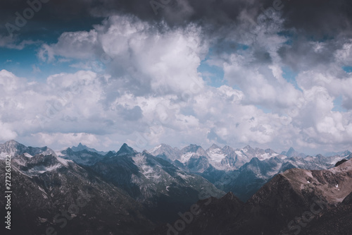 Panorama of mountains scene with dramatic cloudy sky in national park of Dombay