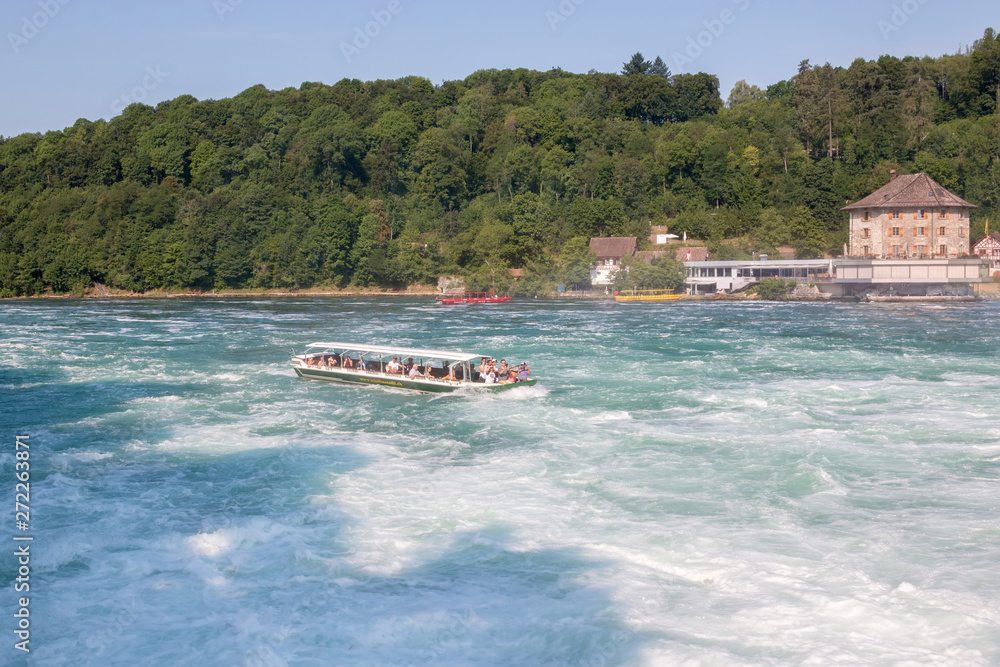 Obraz premium Boat with people floating to the waterfall the Rhine Falls