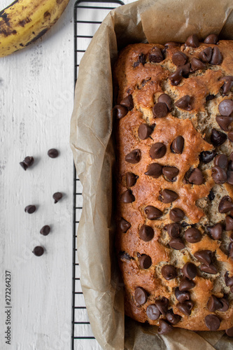 baked chocolate chip banana bread in baking pan flat lay photo