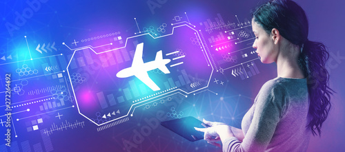 Airplane travel theme with business woman using a tablet computer