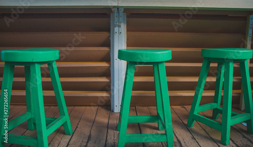 Three-green chairs stand nearby