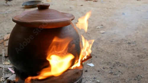 Clay pot on the stove with smoke