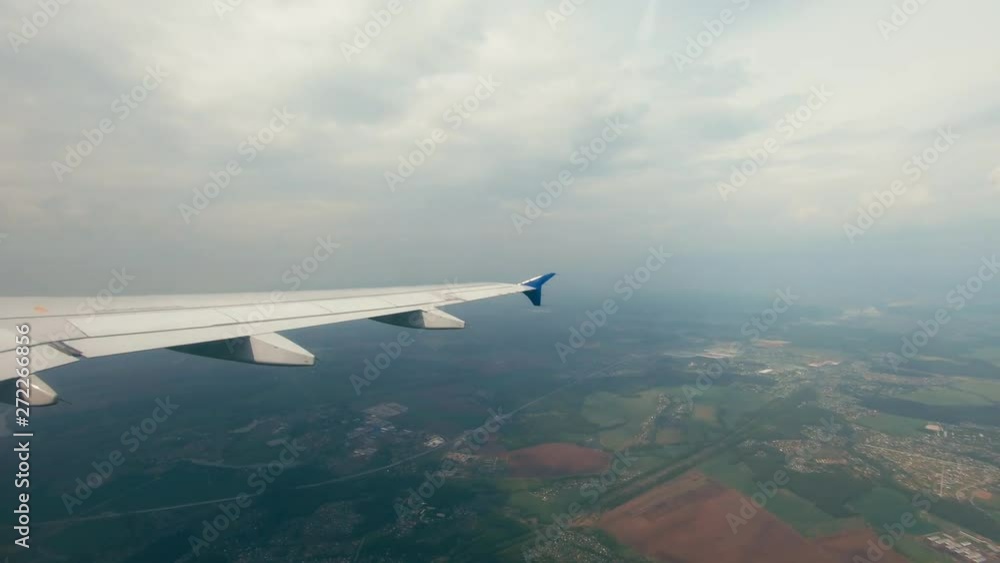 Over the green fields and small settlements of Turkey flying plane. Airplane wing Over the green fields and small settlements of Turkey flying plane. Airplane wing