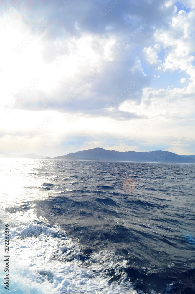 the setting sun in the clouds over the Aegean Sea the setting sun in the clouds over the Aegean Sea