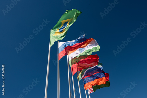 Flags of the BRICS countries in the blue sky