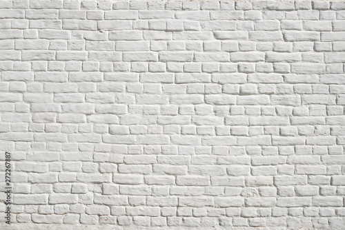 White brick wall with smooth seams  covered with lime or plaster
