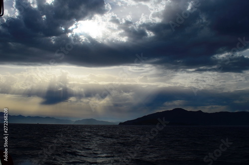 the setting sun in the clouds over the Aegean Sea