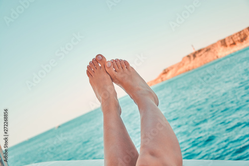 Womans feet on the yacht. Close-up