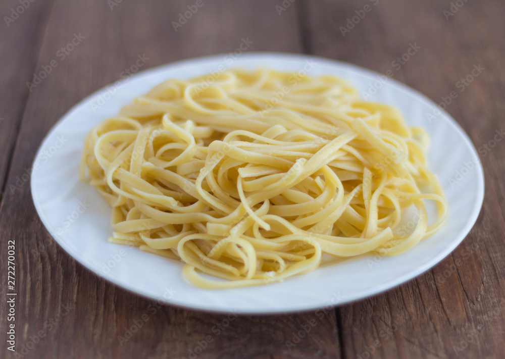 pasta, plate of cooked spaghetti on wooden background pasta, plate of cooked spaghetti on wooden background