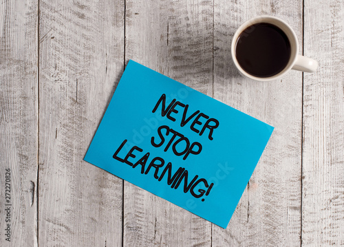 Text sign showing Never Stop Learning. Business photo showcasing keep on studying gaining new knowledge or materials Pastel Colour paper placed next to a cup of coffee above the wooden table