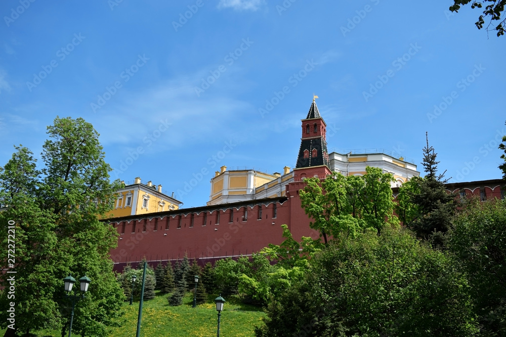 Moscow, Russia - May 13, 2019: The Middle Arsenalnaya Tower surrounded by verdure against the clear blue sky. The view from the Alexander Garden