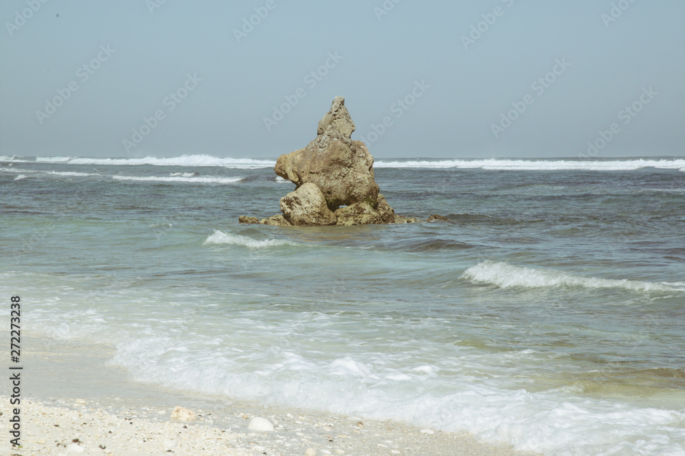 A big rock in the ocean, beautiful landscape view from the beach