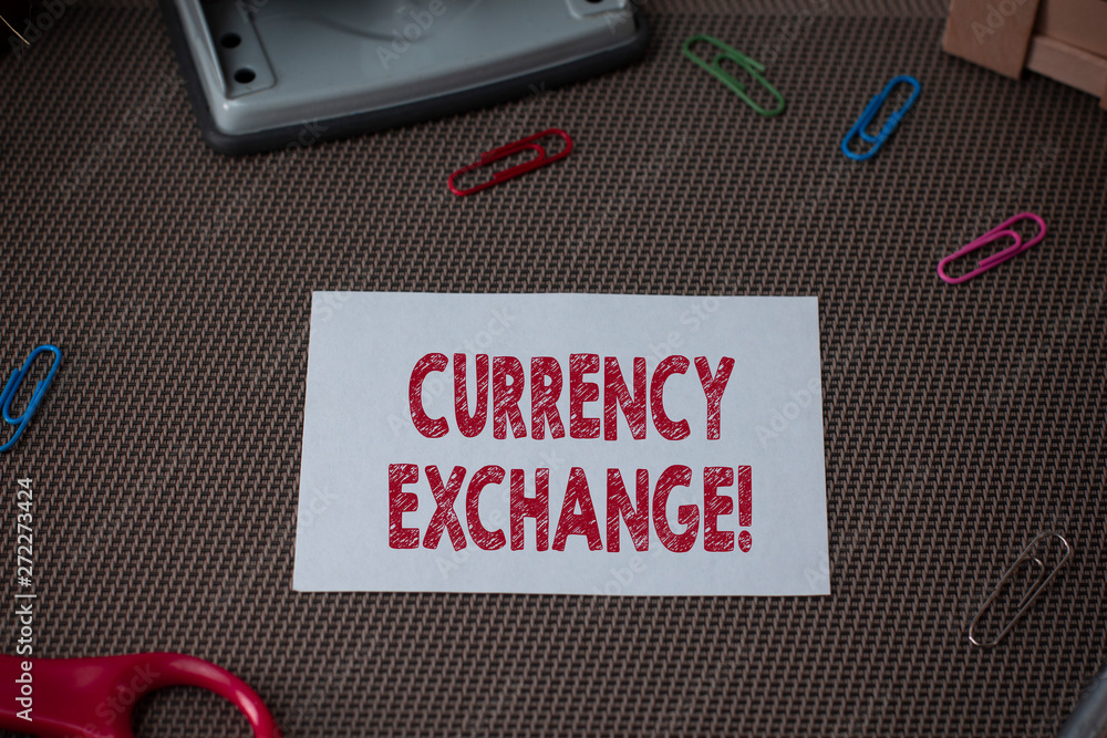 Conceptual hand writing showing Currency Exchange. Concept meaning Process of changing one currency into another ForEx Scissor and writing equipments sheet above textured backdrop