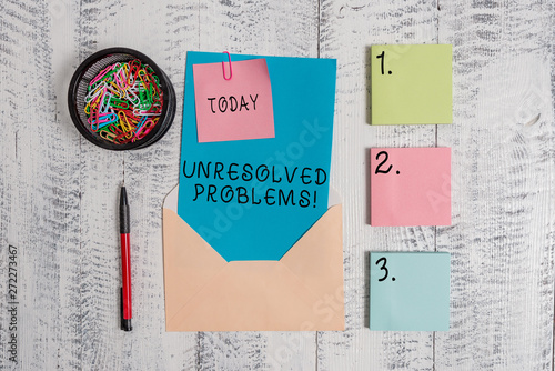 Writing note showing Unresolved Problems. Business concept for those Queries no one can answer Unanswerable Questions Envelope letter sticky note ballpoint clips on wooden background photo