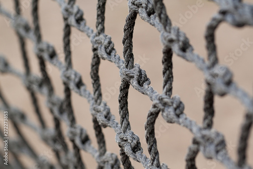 rough decorative net with large nodes creates a rhythmic background © guppys