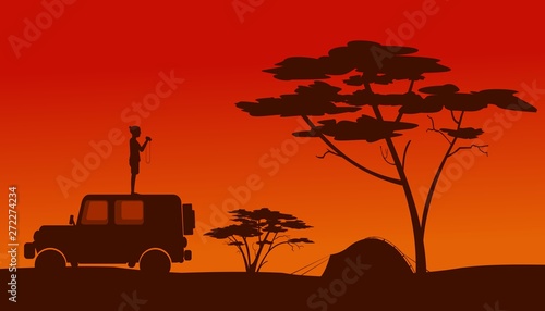 a man standing on the roof of a car and a tent in the African savannah