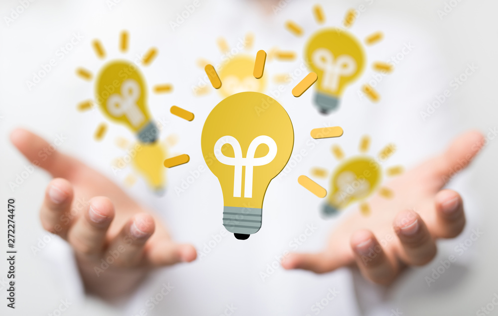 holding illuminated light bulb, idea, innovation and inspiration concept. holding illuminated light bulb, idea, innovation and inspiration concept.