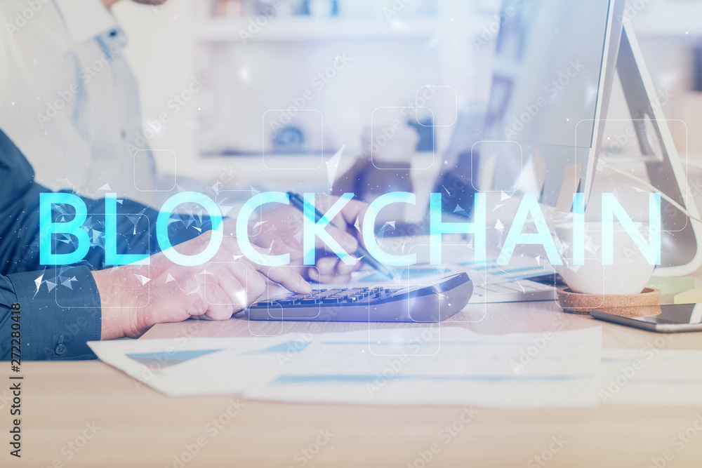 Crypto currency theme hologram with businessman working on computer on background. Concept of blockchain. Double exposure. Crypto currency theme hologram with businessman working on computer on background. Concept of blockchain. Double exposure.