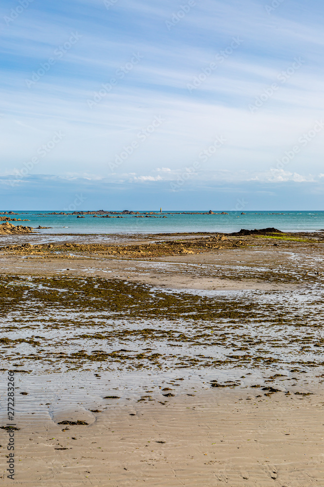 Looking out to sea from a beach at low tide, on the island of Jersey