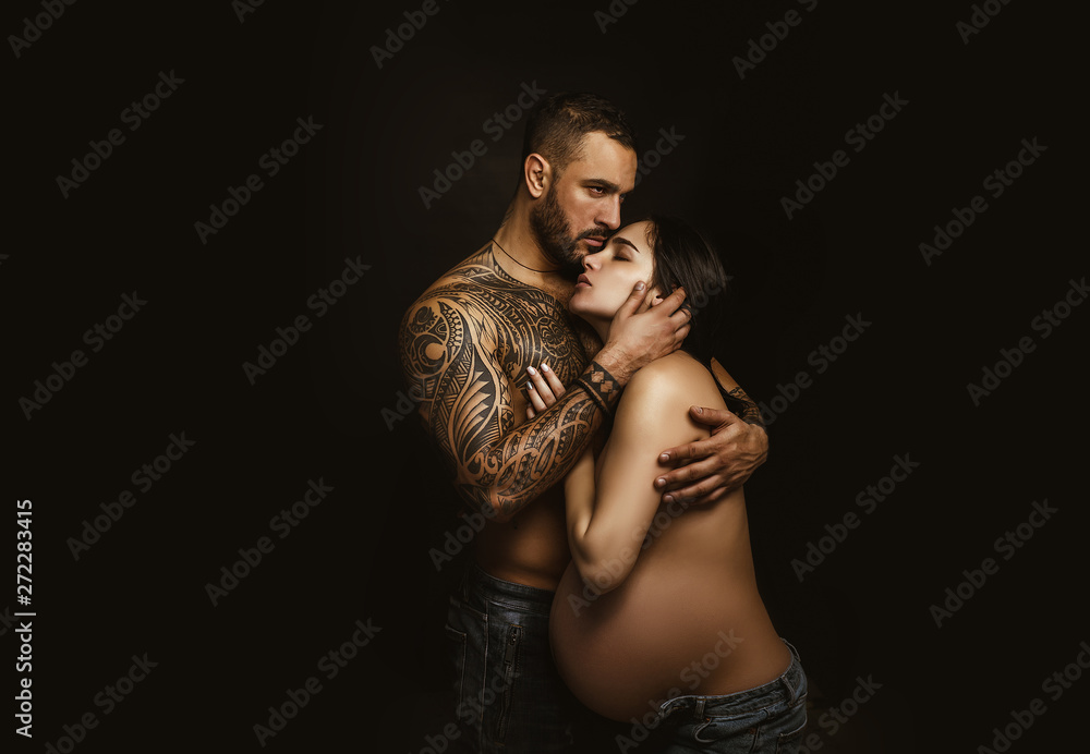 Couple in love pregnant cuddling, waiting for baby. Real romantic  passionate moment. Bearded man with tattoo clasping beautiful girlfriend.  Emotive of sexy couple. Stock Photo | Adobe Stock