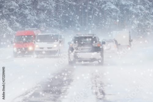Winter, snow, Blizzard, poor visibility on the road. Car during a Blizzard on the road with the headlights. © Shcherbyna