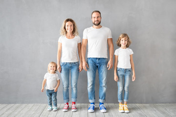 Happy family standing against grey background