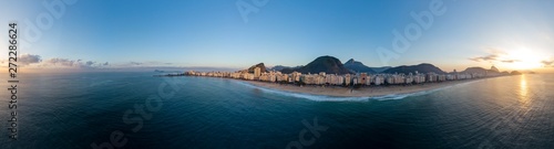 Sunrise 360 degree full panoramic aerial view of Copacabana beach and neighbourhood in Rio de Janeiro with the sun rising above the Sugarloaf mountain and the Corcovado mountain in the background
