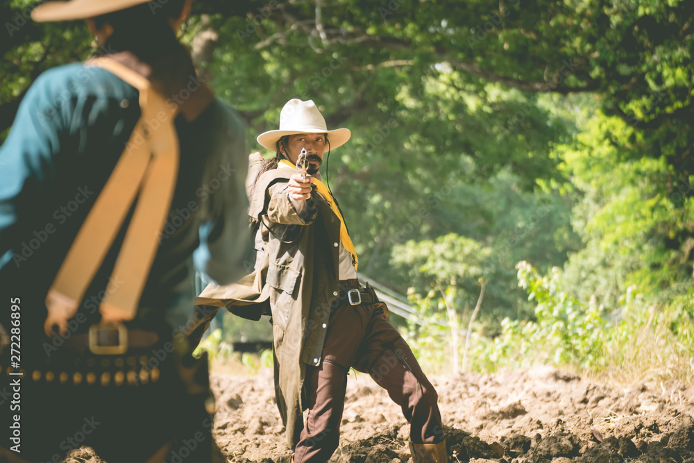 cowboy with gun prepares to gunfight. 