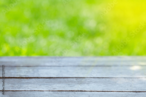 Empty wooden table over bokeh natural background