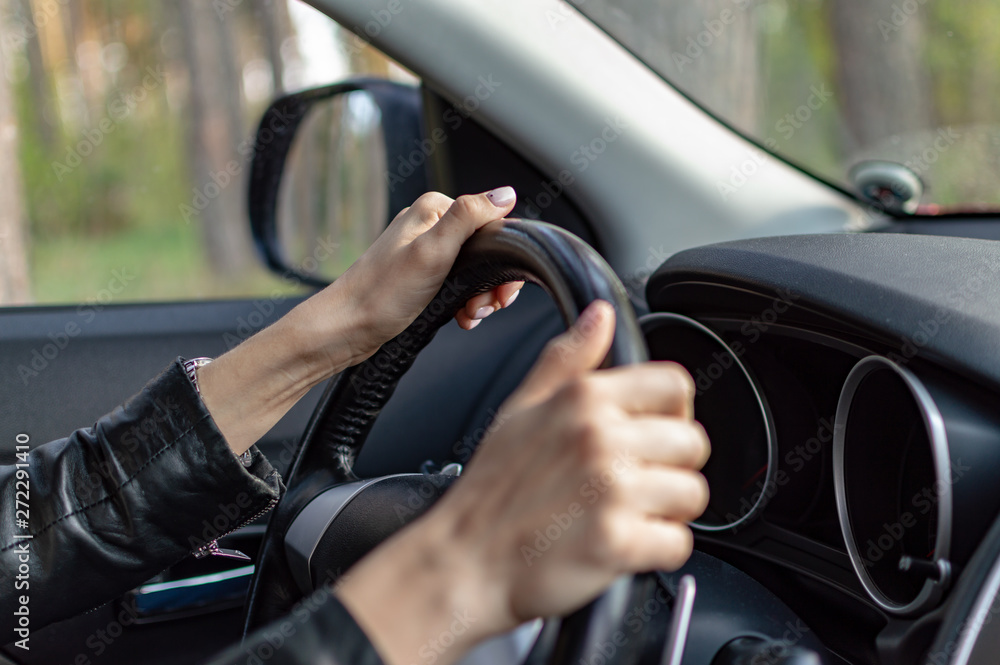 woman's hand with a clock in the car woman's hand with a clock in the car
