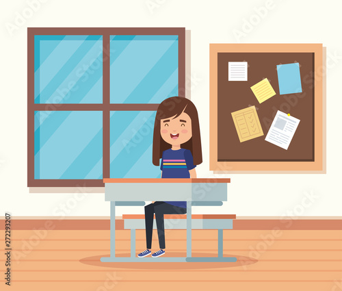 girl child in the classroom with note board and desk
