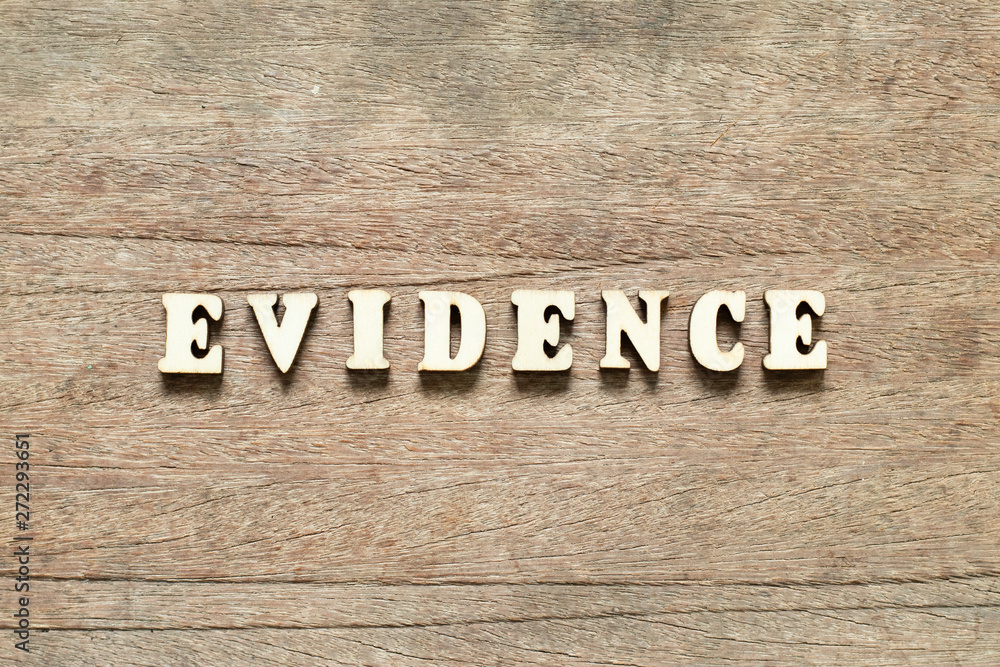 Letter block in word evidence on wood background Letter block in word evidence on wood background