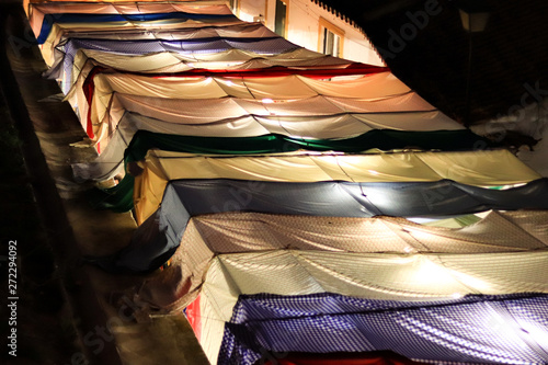 Colorful fabrics cover in an arab market at night