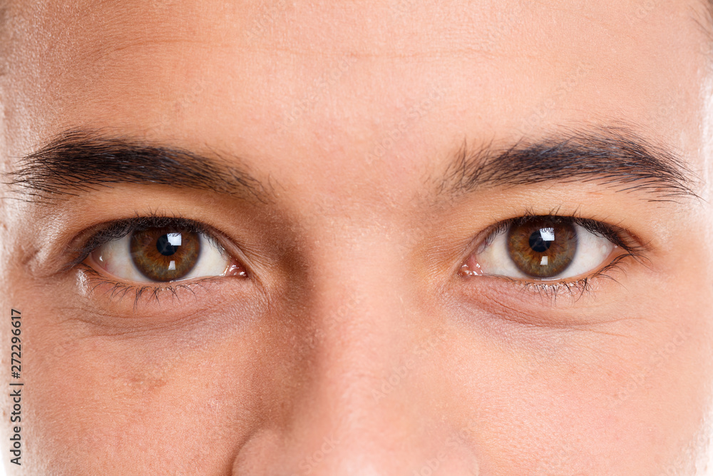 Fototapeta premium Eyes of a young latin man face eye macro shot person people