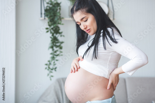 Pregnant woman having a backache. Expecting woman suffering from pain. Free Download Pregnant woman having a backache. Expecting woman suffering from pain. - GFXLoad