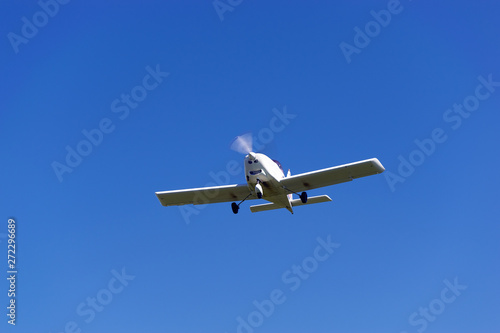 A light motor plane on a blue sky