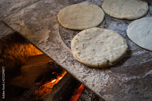 Handmade Tortillas Cooking over Fire in Traditional Guatemalan Kitchen