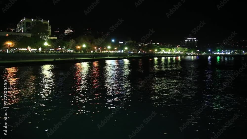 Panorama view of Yalta town from the Black sea. Night life on embankment. Crimea Panorama view of Yalta town from the Black sea. Night life on embankment. Crimea