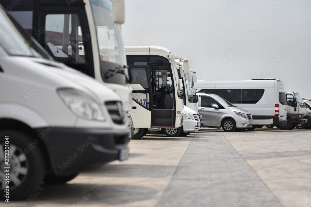 buses and minibuses shuttles taxi parked in row