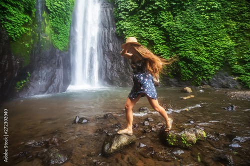 Woman near Munduk waterfal on Bali, Indonesia